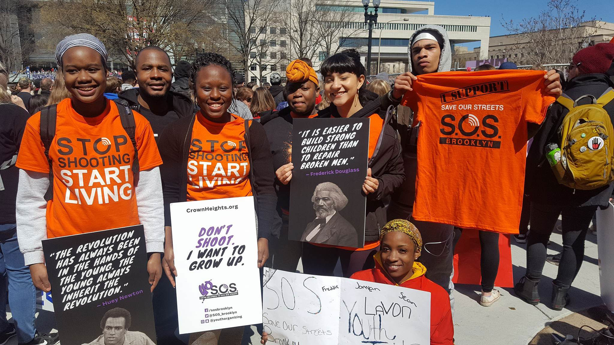 Photo showing a students in Washing DC wearing an orange t-shirt at the 2018 March for Our Lives 